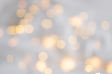 Xmas bokeh. Festive soft background with yellow bokeh of the garland. Christmas theme. The backdrop...