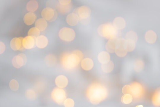 Xmas bokeh. Festive soft background with yellow bokeh of the garland. Christmas theme. The backdrop for web design, greeting, or invitation card. Happy holidays celebration