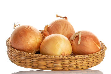 Four round aromatic onions in a straw plate, close-up, isolated on white.