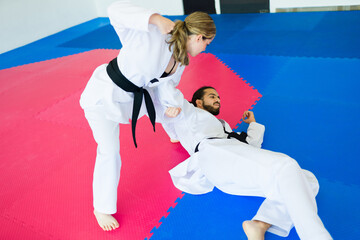 Caucasian woman winning a martial arts competition