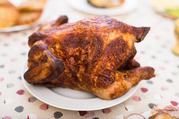 ruddy chicken fried whole on a plate on the festive table