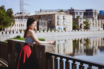 Fashion portrait of young, happy, elegant redhead curly woman, girl in hat and casual clothes. French style. Walking, relax in the city street. Sunny day.