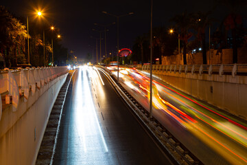 Night traffic, car lights at night on a city street