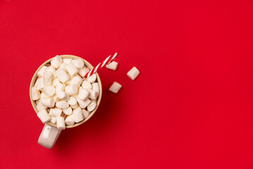 Mug with Hot Cocoa and Marshmallows on Red Background Concept for New Year's Drink Top View Copy Space