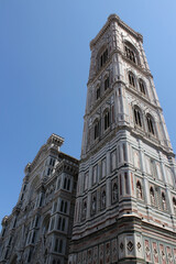 Giotto's Bell Tower next to the front façade of the Cathedral of Santa Maria Del Fiore in Florence, Italy. Vertical