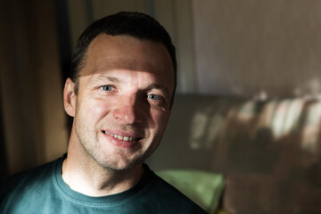 Close up face portrait of smiling young adult man