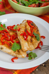 Roasted chicken meat in portions served on wooden table