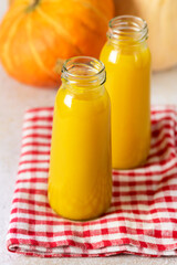 Freshly Squeezed Pumpkin Juice in Bottle Bottle with Juice on Napkin Vegetarian Breakfast Healthy food Vertical