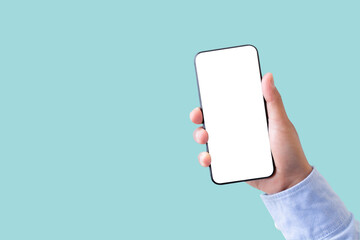 Hand holding smartphone with blank screen isolated on pastel green color background with clipping path. ideas design business concept.