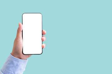 Hand holding smartphone with blank screen isolated on pastel green color background with clipping path. ideas design business concept.