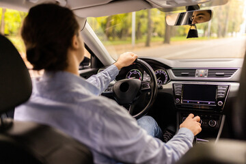 Businessman in car. Rear view of young handsome man while driving a car