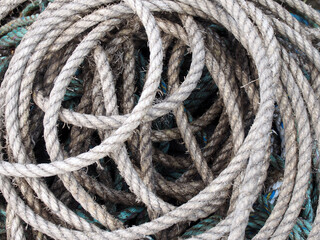 fully frame image of old grey coiled marine or fishing rope