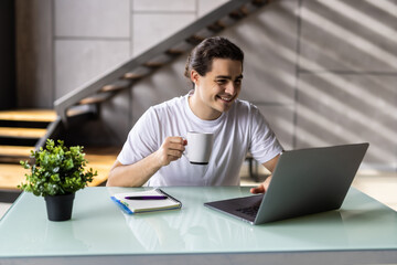 Freelancer man working at home drinking coffee from home