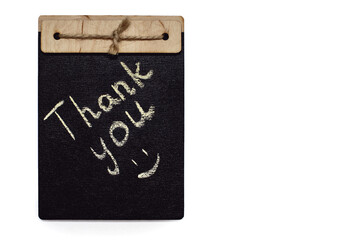 The inscription thank you is written in chalk on a black board on a white background. Gratitude in the form of the inscription thank you in white chalk on a cute board. Free space for text