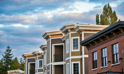 Top of residential building on cloudy sky background