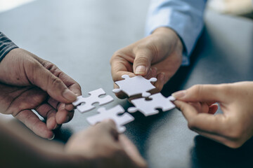 People holds in hand a jigsaw puzzle. Business solutions, success and strategy.Group of business...