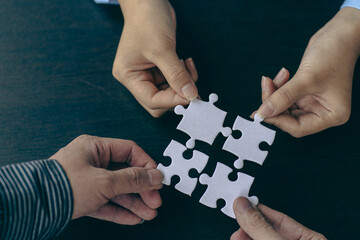 People holds in hand a jigsaw puzzle. Business solutions, success and strategy.Group of business...
