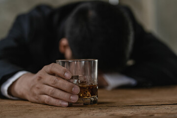 
Close-up of serious businessman holding whiskey glass shows concept of executive privilege. Soft focus. Close-up view of two men in formal wear whiskey clashing glasses.