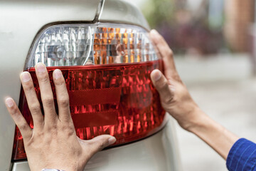 young man checking a car clean the car Young Asian man holding a microfiber in his hand and polishing a car. Car inspection and maintenance services.
