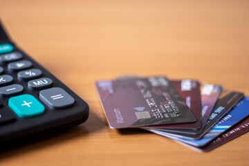 Three credit cards put a spoon on the table.