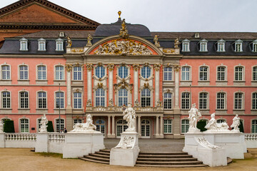 Great close-up view of the famous Electoral Palace with its pink rococo facade at the main entrance of the south wing in Trier, Germany. It now houses various offices of the federal government. - obrazy, fototapety, plakaty