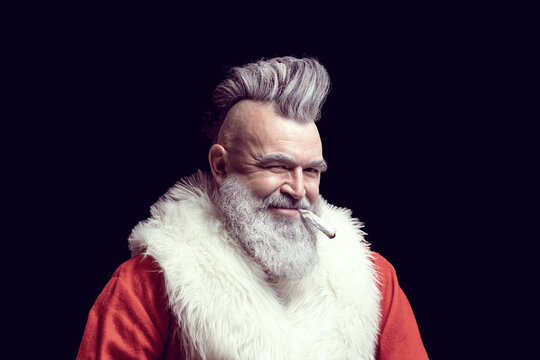 New Year and Christmas in the company of an unusual bad Santa. Dangerous gray-haired old man Santa. Tobacco smoking crazy Santa claus with mohawk