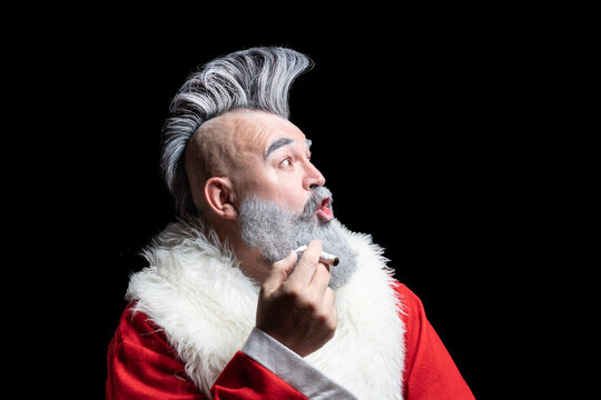 New Year and Christmas in the company of an unusual bad Santa. Tobacco smoking crazy Santa claus with mohawk. Dangerous gray-haired old man Santa