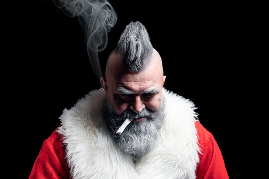 Dangerous gray-haired old man Santa. Tobacco smoking crazy Santa claus with mohawk. New Year and Christmas in the company of an unusual bad Santa