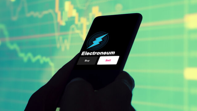 September 13th 2022, London UK. An investor's analyzing the electroneum coin on screen. A phone shows the crypto's prices to invest