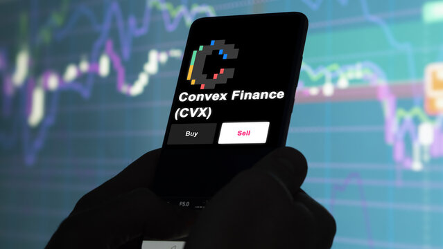 September 13th 2022, London UK. An investor's analyzing the Convex Finance (CVX) coin on screen. A phone shows the crypto's prices to invest