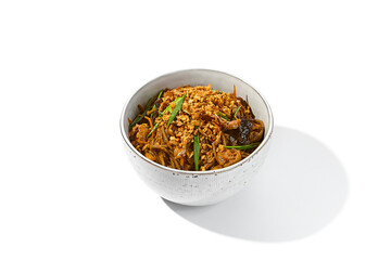 Asian fried buckwheat noodles with chicken and vegetables isolated on white background Japanese fried noodles in teriyaki sauce in ceramic bowl. Stir-fry soba with chicken in minimal style. Wok menu