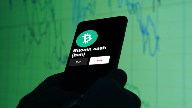 Bitcoin cash $BCH coin on screen. A phone shows the crypto's prices to invest