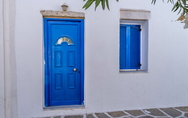 Blue door and shutters at a house on Paros island in Greece
