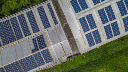 Solar panels on factory roof photovoltaic solar panels absorb sunlight as a source of energy to...