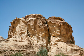 Fototapeta premium Petra, Jordan, November 2019 - A tall rocky mountains on a rock