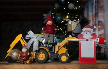 concept of new year business greetings in construction company. toy bulldozer - excavator, souvenir...