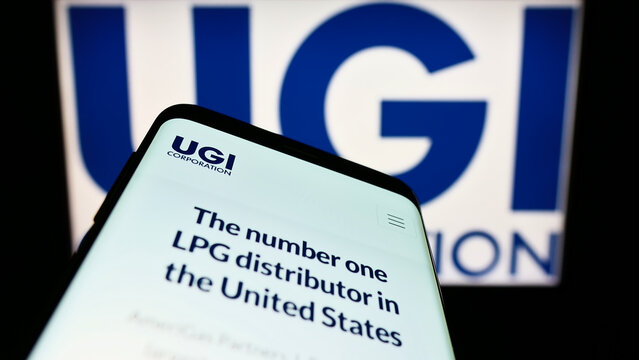 Stuttgart, Germany - 10-18-2022: Mobile phone with website of US energy company UGI Corporation on screen in front of business logo. Focus on top-left of phone display.
