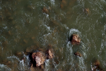 person in the river, river in the river, stream of water, 
rocks in the river, fish in the river, natural life