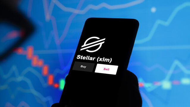 An investor's analyzing the stellar xlm coin on screen. A phone shows the Stellar $XLM ETF's prices to invest