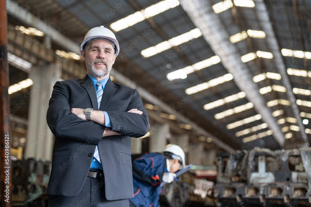 Wall mural senior businessman wearing helmet safety standing arms crossed in heavy metal factory industrial. in