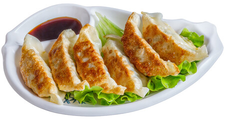 5 giozas grillés avec sauce asiatique sur lit de salade png