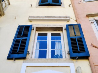 A window with blue shutters. Teotoki Square. Town Hall Square. Old town. Kerkyra. The island of Corfu. Greece