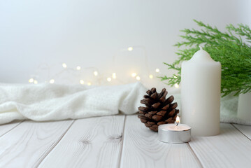 Happy festival concept with white candle and flame Decorated with pine leaves, white fabric and...