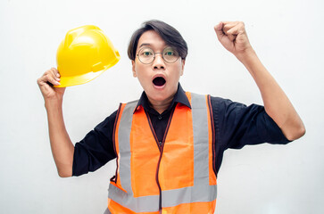 Happy ecstatic young Asian male construction worker, engineer, builder raising his fists doing yes gesture celebrating success. billboard model advertisment concept. 