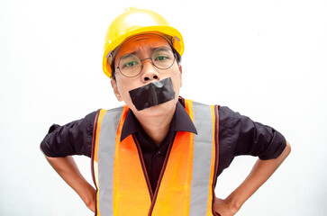 Young asian construction worker doing protest by covering mouth with tape isolated over white background. labour day concept.  freeedom of speech concept.