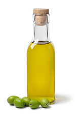 Bottle olive oil with a heap of fresh raw green olives isolated on white background