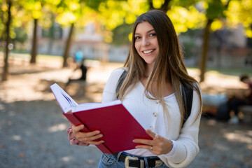 Fototapeta premium Female college student reading a book