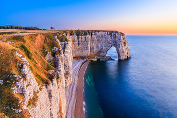 Normandy, France. Etretat village cliffs with the Manneporte arch and the Valaine beach. - obrazy, fototapety, plakaty