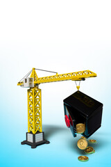 Background with a construction crane and a bank safe from which coins with a pound sign are pouring out. Template on the theme of investments in construction and I will lose money on investments.