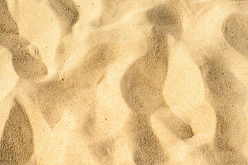 Close-up of yellow sand on the beach. Small grains of sand on a clean beach. Toned photo with low depth of field.
